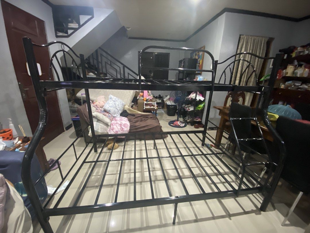 Black Metal Bunk Bed Frame Double Twin Size (Category: Bed Frames & Mattresses) located in Quezon City. Submitted by mjgaudier (Listing ID 1470269849, Image 3). Description: - Type: Black metal bunk bed frame - Size: Double on bottom, Twin on top - Safety: Built-in side ladder and standard upper guardrails - Support: Sturdy metal slats included for both levels - Convenience: Disassembles into pieces for easy transport and moving - Finish: Clean b