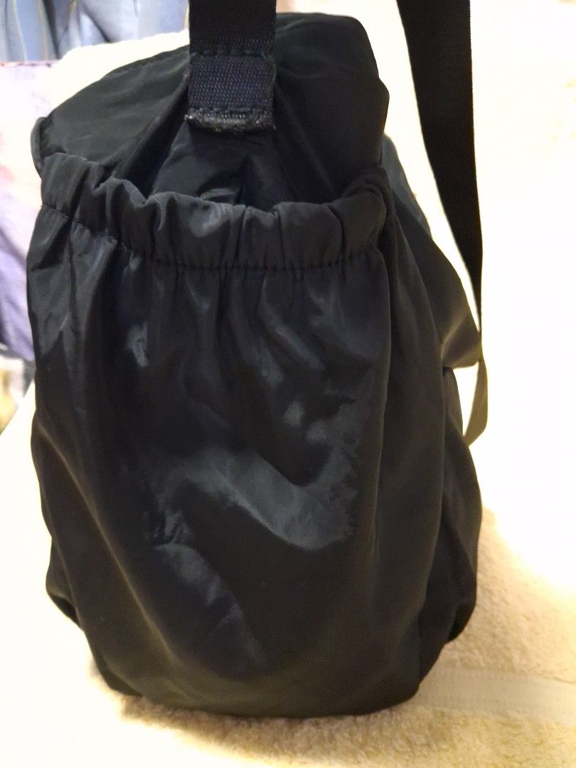 Black Nylon Shoulder Bag with Adjustable Strap (Category: Shoulder Bags) located in Angeles City. Submitted by anneps (Listing ID 1470217144, Image 3). Description: - Color: Black - Material: Durable, easy-to-clean nylon with sturdy metal hardware - Straps: Dual top handles and a detachable, adjustable crossbody strap - Storage: Spacious main compartment with a secure zip-top closure - Organization: Multiple exterior slip pockets for quick access