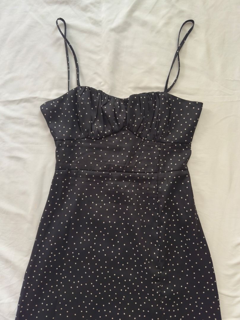 Black Polka Dot Slip Midi Dress with Front Split Small (Category: Dresses) located in Cebu City. Submitted by _t.rix (Listing ID 1470198889, Image 2). Description: - Color & Pattern: Classic black with small white polka dots - Design: Spaghetti straps, ruched bust detail, and fitted bodice - Features: Sexy high front slit, trendy back cutout with tie closure, and concealed lower back zipper - Comfort: Lightweight fabric with full inner lining - C