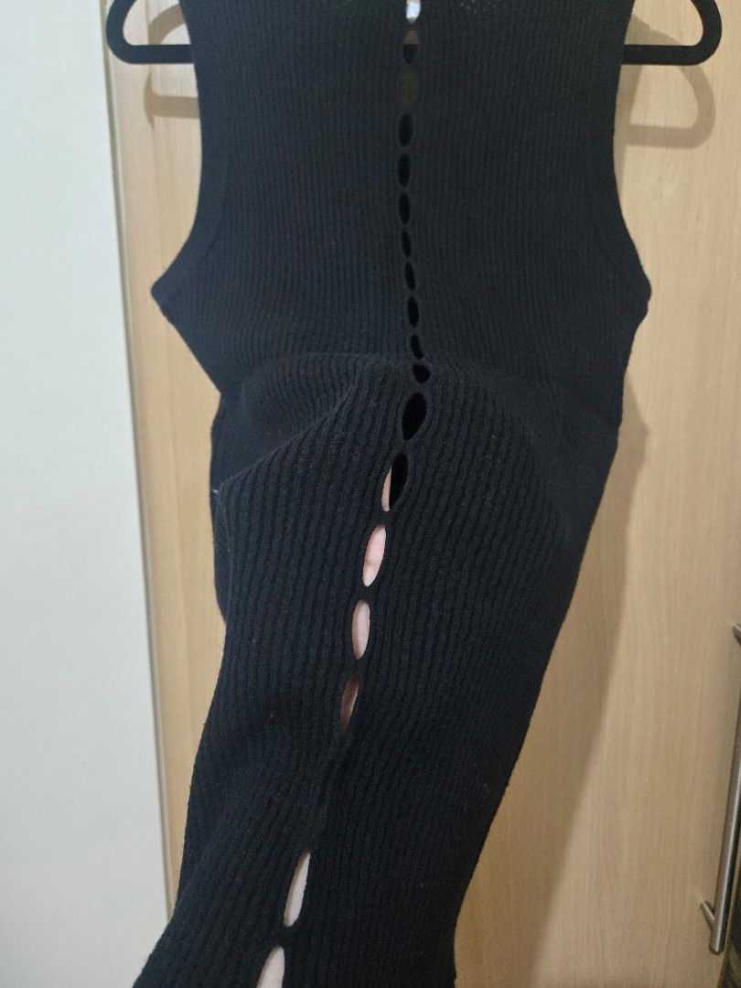 Black Ribbed Tank Top with Cutouts (Category: Sleeveless) located in Pasay City. Submitted by samcas (Listing ID 1470268299, Image 3). Description: - Style: Sleeveless black ribbed knit top - Fit: Stretchy fabric with a flattering snug fit - Detail: Unique vertical button-loop closure down the back - Versatility: Perfect basic piece that goes well with jeans, shorts, or skirts - Condition: Excellent quality.
