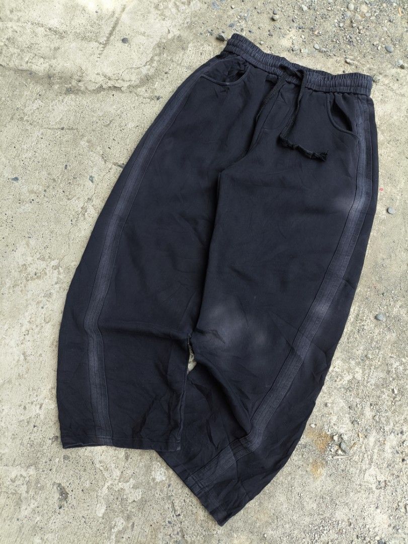 Black Sweatpants with Side Stripes and Drawstring Waist (Category: Joggers) located in Manila. Submitted by maryaganda (Listing ID 1470192978, Image 1). Description: - Color: Black - Fit: Relaxed fit with wide legs - Material: Soft cotton, super comfortable - Features: Elastic waistband with thick black drawstring, two front pockets, and stylish side stripe panels - Condition: Pre-loved with natural fading on the fabric and stripes from washing -