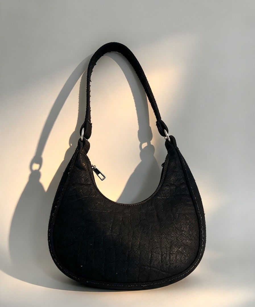 Black Textured Crescent Shoulder Bag Hobo Bag (Category: Shoulder Bags) located in Manila. Submitted by yukis_thrift (Listing ID 1470187384, Image 1). Description: - Style: Trendy crescent hobo silhouette with a structured base - Material: Unique crinkled leather-like textured exterior - Hardware: Silver-tone metal rings and rectangular zip pull - Closure: Secure top zip closure - Size: Compact and lightweight for everyday wear.