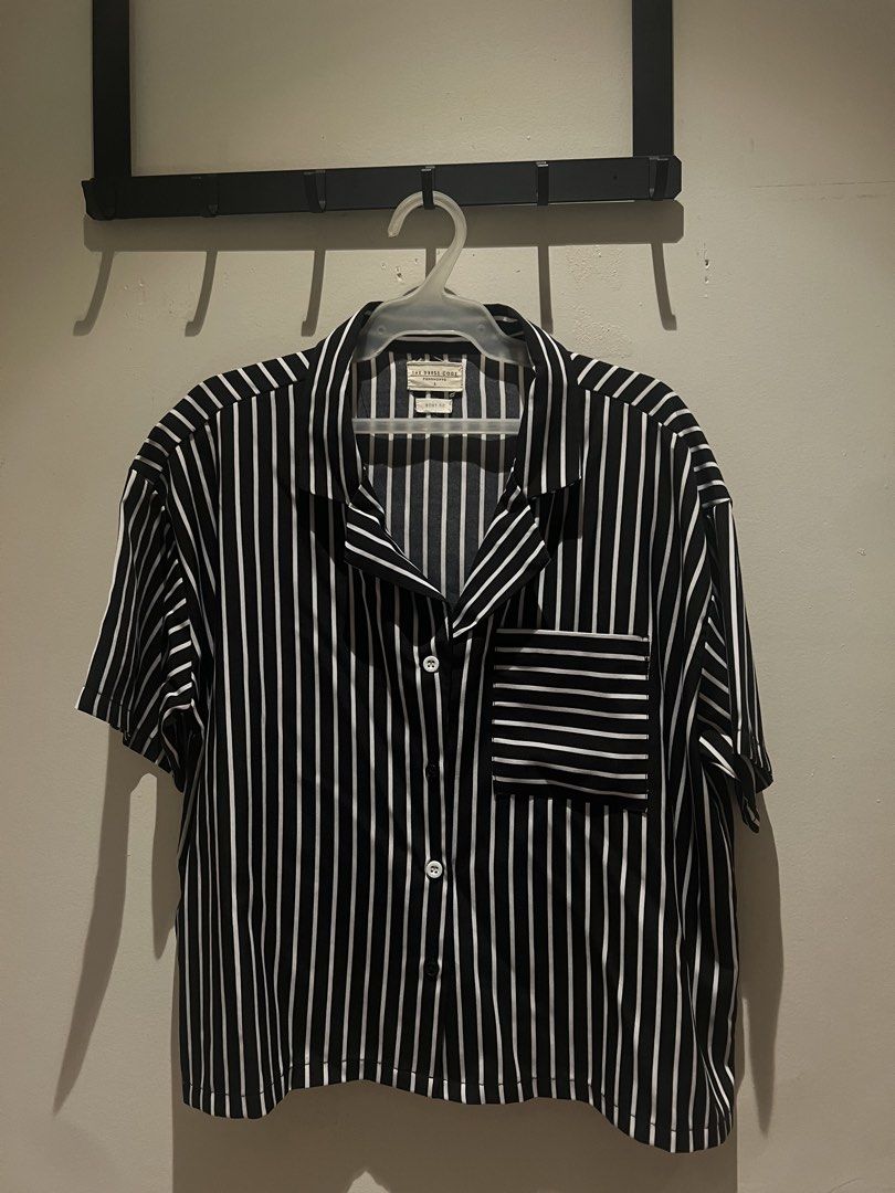 Black White Striped Short Sleeve Shirt (Category: Shirts) located in Malabon City. Submitted by chrsgns (Listing ID 1470220664, Image 1). Description: - Brand: The Dress Code - Size: L - Design: Black and white vertical stripes with horizontal stripe chest pocket - Style: Cuban collar, short sleeves, boxy fit - Details: White front buttons - Material: Lightweight fabric - Condition: Great for easy, casual styling.