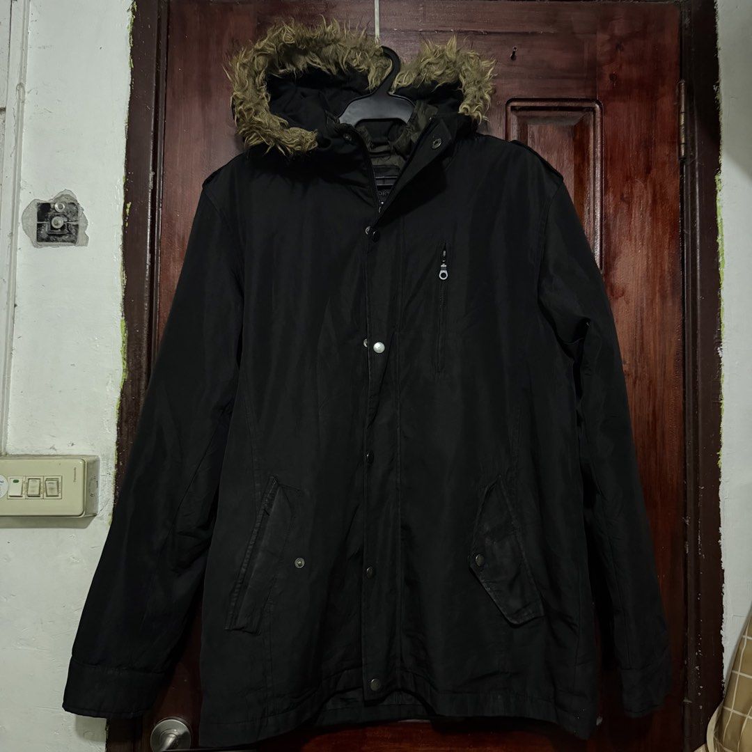 Black winter parka jacket with fur hood (Category: Coats, Jackets and Outerwear) located in Pasig City. Submitted by styledfitsbymae (Listing ID 1470255139, Image 3). Description: - Color: Black - Condition: Excellent (worn only a few times) - Features: Thick material, super warm for cold weather - Hood: Equipped with stylish faux fur trim - Closure: Secure full zip and button front closure - Pockets: Multiple front flap pockets and a convenient 