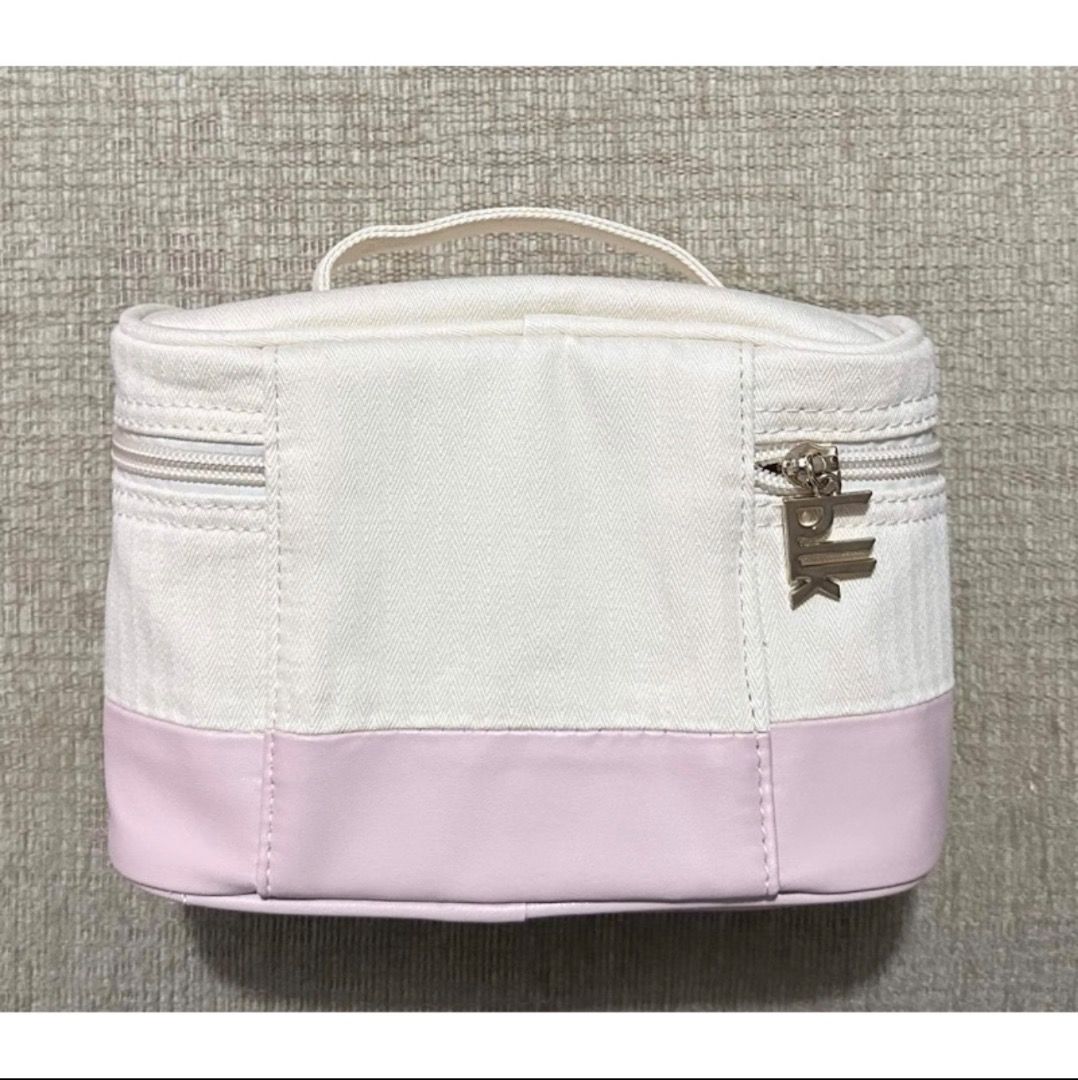 BLK Travel Kit (Category: Purses & Pouches) located in Pasig City. Submitted by shanemendozaa (Listing ID 1470344432, Image 2). Description: - Brand/Model: BLK Travel Kit vanity pouch - Design: Two-tone off-white canvas upper and pastel pink lower section - Features: Top handle for convenient carrying and custom BLK logo zipper pull - Interior: Fully lined, spacious main compartment for makeup and toiletries - Condition: Preloved, with signs of u