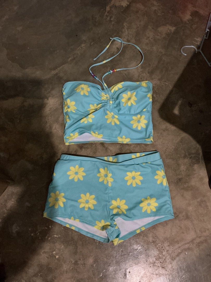Blue Daisy Print Halter Bikini Set with Shorts (Category: Bikinis & Swimsuits) located in Santa Barbara. Submitted by user82739292 (Listing ID 1470188511, Image 2). Description: - Color & Print: Light blue with cheerful yellow daisy flowers - Top: Ruched bandeau with a stylish halter strap featuring colorful beads - Bottoms: Matching comfortable boy-shorts - Ideal for: Beach trips, pool parties, and tropical vacations - Condition: Brand new and r