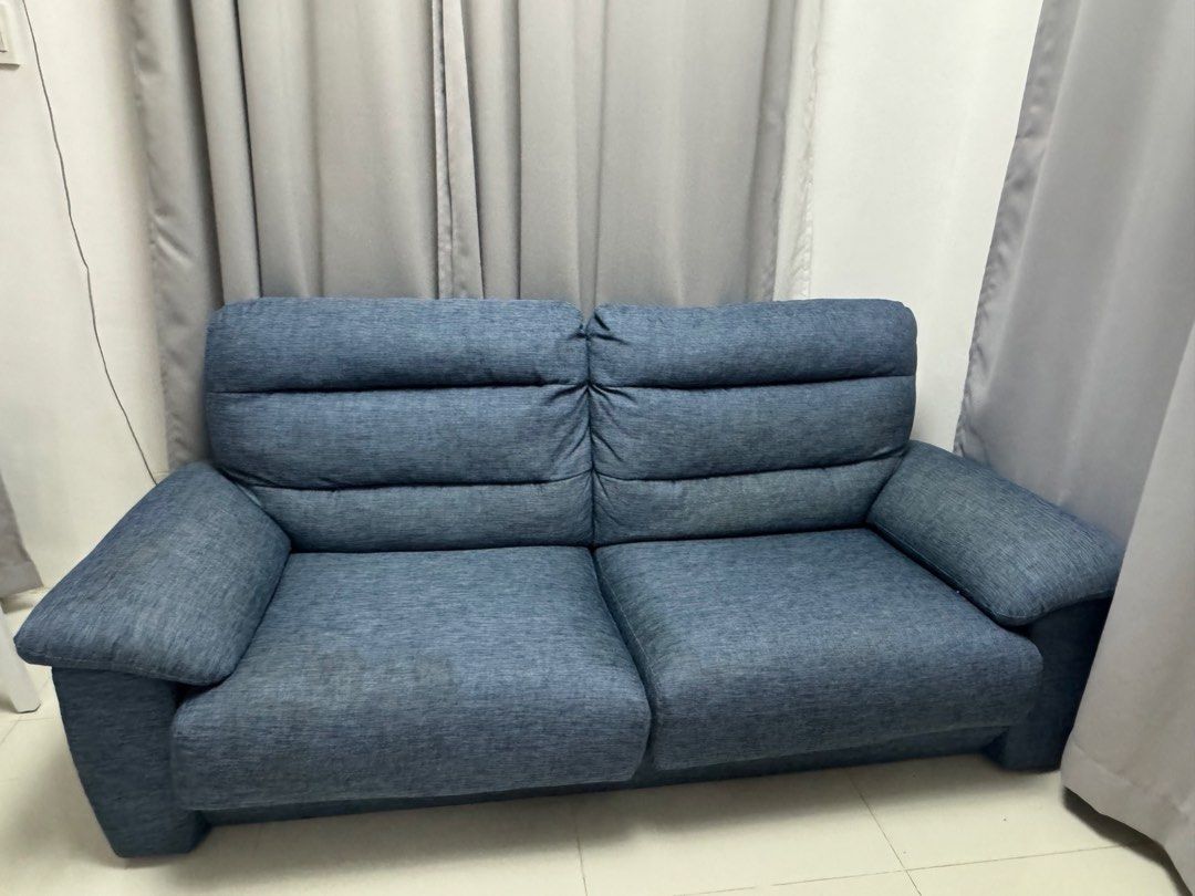 Blue fabric 2-3seater sofa with plush cushions (Category: Sofas) located in Cavite. Submitted by ravaraemg (Listing ID 1470228200, Image 2). Description: - Type: Comfortable 2-seater sofa - Material: Durable blue textured fabric - Design: Thick cushioned backrest with horizontal stitching and wide padded armrests - Build: Sturdy construction with clean, modern lines - Ideal For: Living rooms, bedrooms, or home studies - Style: Neutral tone that e