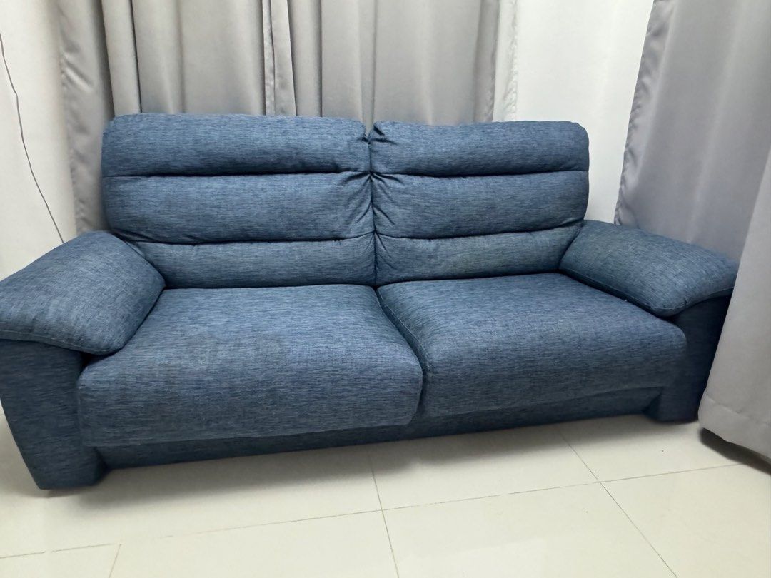 Blue fabric 2-3seater sofa with plush cushions (Category: Sofas) located in Cavite. Submitted by ravaraemg (Listing ID 1470228200, Image 3). Description: - Type: Comfortable 2-seater sofa - Material: Durable blue textured fabric - Design: Thick cushioned backrest with horizontal stitching and wide padded armrests - Build: Sturdy construction with clean, modern lines - Ideal For: Living rooms, bedrooms, or home studies - Style: Neutral tone that e