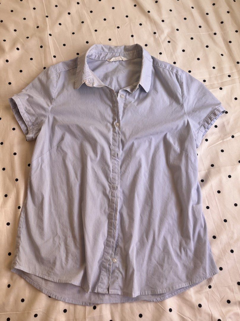 Blue striped short sleeve button-up shirt (Category: Blouses) located in Manila. Submitted by chimcheese (Listing ID 1470151861, Image 1). Description: - Style: Classic blue and white pinstripe short-sleeve shirt - Design: Point collar, front button closure, curved hem, and back pleat for easy movement - Fabric: Lightweight and breathable - Fit: Standard fit - Versatility: Ideal for office wear or smart casual outfits.