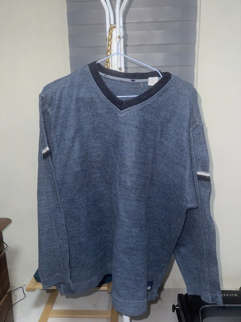 Blue V-Neck Cotton Blend Sweater (Category: Longsleeves) located in La Trinidad. Submitted by prelovedandfindsbyji (Listing ID 1470285029, Image 1). Description: - Color & Style: Blue knit sweater with a contrasting dark V-neck and stylish striped accents on the upper sleeves - Size: L/G (16-18) with a comfortable, relaxed fit ideal for cooler weather - Material: Premium blend of 58% cotton and 42% acrylic - Care: Easy to wash and maintain - Orig