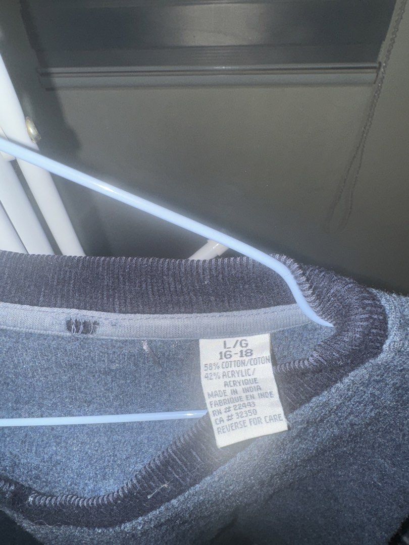 Blue V-Neck Cotton Blend Sweater (Category: Longsleeves) located in La Trinidad. Submitted by prelovedandfindsbyji (Listing ID 1470285029, Image 2). Description: - Color & Style: Blue knit sweater with a contrasting dark V-neck and stylish striped accents on the upper sleeves - Size: L/G (16-18) with a comfortable, relaxed fit ideal for cooler weather - Material: Premium blend of 58% cotton and 42% acrylic - Care: Easy to wash and maintain - Orig