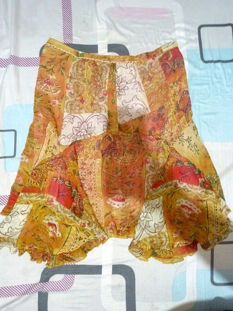 Boho Floral Patchwork Print Ruffle Hem Skirt (Category: Skirts) located in Iloilo. Submitted by xya.xoxo28 (Listing ID 1470262672, Image 1). Description: - Style: Boho chic patchwork floral skirt - Colors: Warm orange, yellow, and white tones - Fit: Fitted waistband with a flattering flared shape and ruffled hem - Material: Lightweight fabric, perfect for sunny days - Styling: Easy to pair with simple plain tops for casual outings.