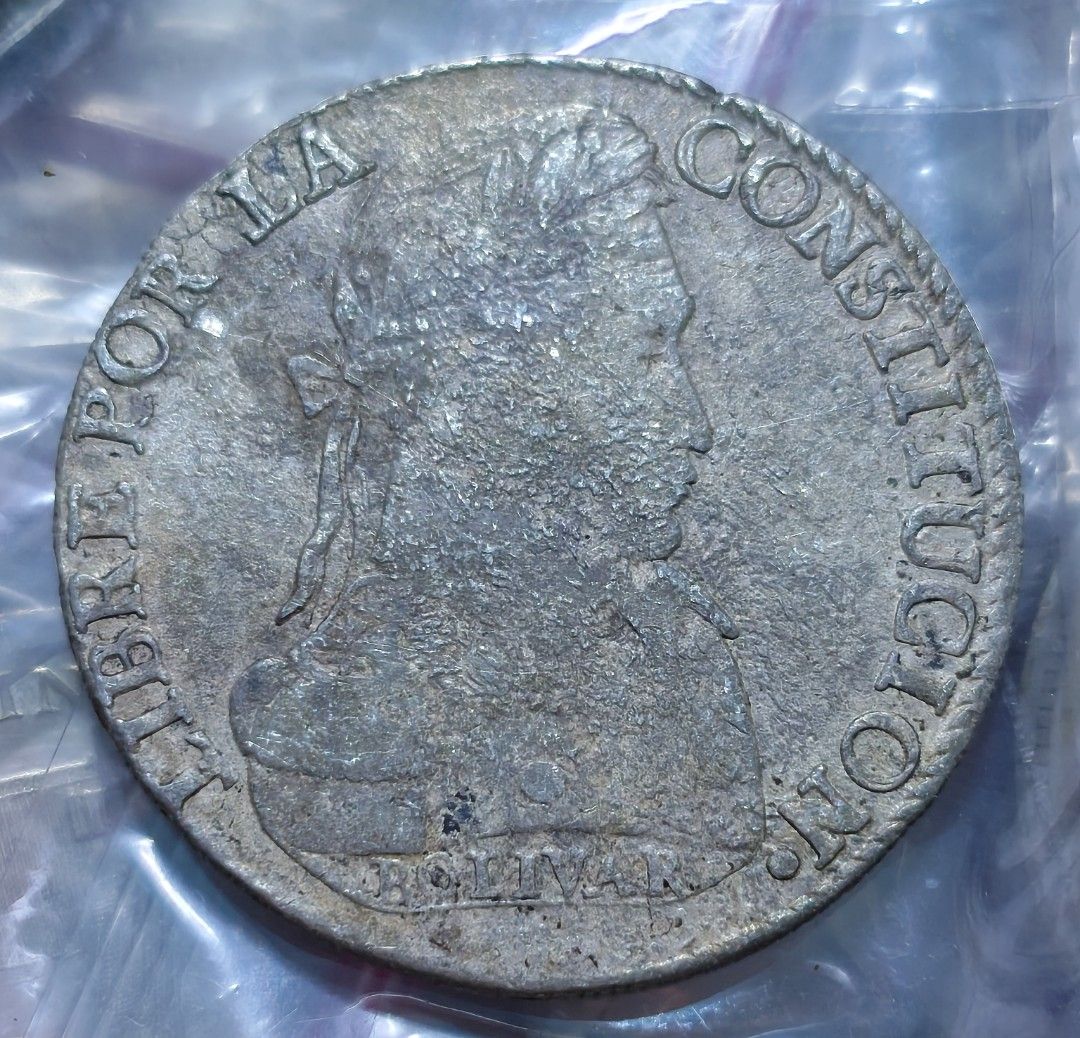 Bolivia 8 Soles Silver Coin 1837 (Category: Currency) located in Taguig. Submitted by ezekiel103 (Listing ID 1470221897, Image 2). Description: - Authentic 1837 Bolivia silver coin - Obverse features Republica Bolivia text, tree, and alpacas - Reverse features Bolivar portrait and Libre Por La Constitucion text - Visible mint marks near the bottom edge - Features heavy natural toning, surface wear, and dark patches from circulation - Details rema