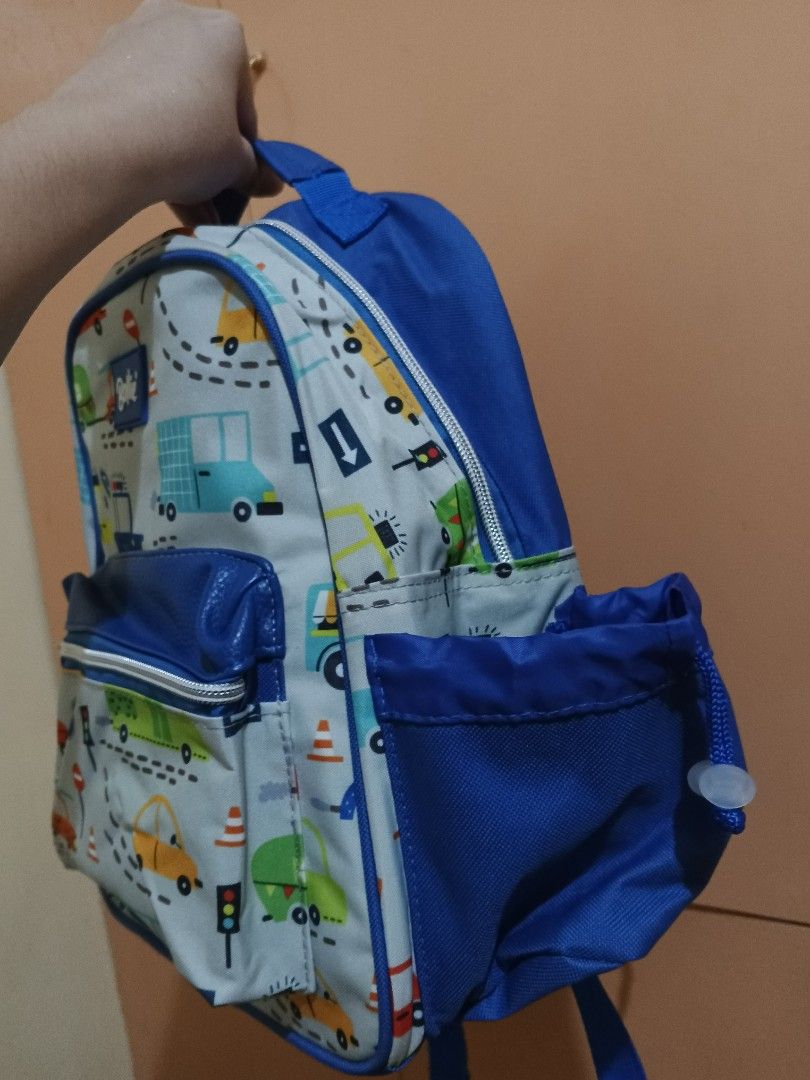 Bollie Kiddie Backpack Car Print (Category: Other Babies Going Out Needs) located in Lapu Lapu. Submitted by dawatkrist14304 (Listing ID 1470295804, Image 3). Description: - Brand new with tag attached - Fun, colorful cars, trucks, and road signs design on a light grey base - Vibrant blue trim, straps, and side pockets - Front zippered pocket for extra storage - Mesh padded back panel for breathability and comfort - Adjustable shoulder straps wit
