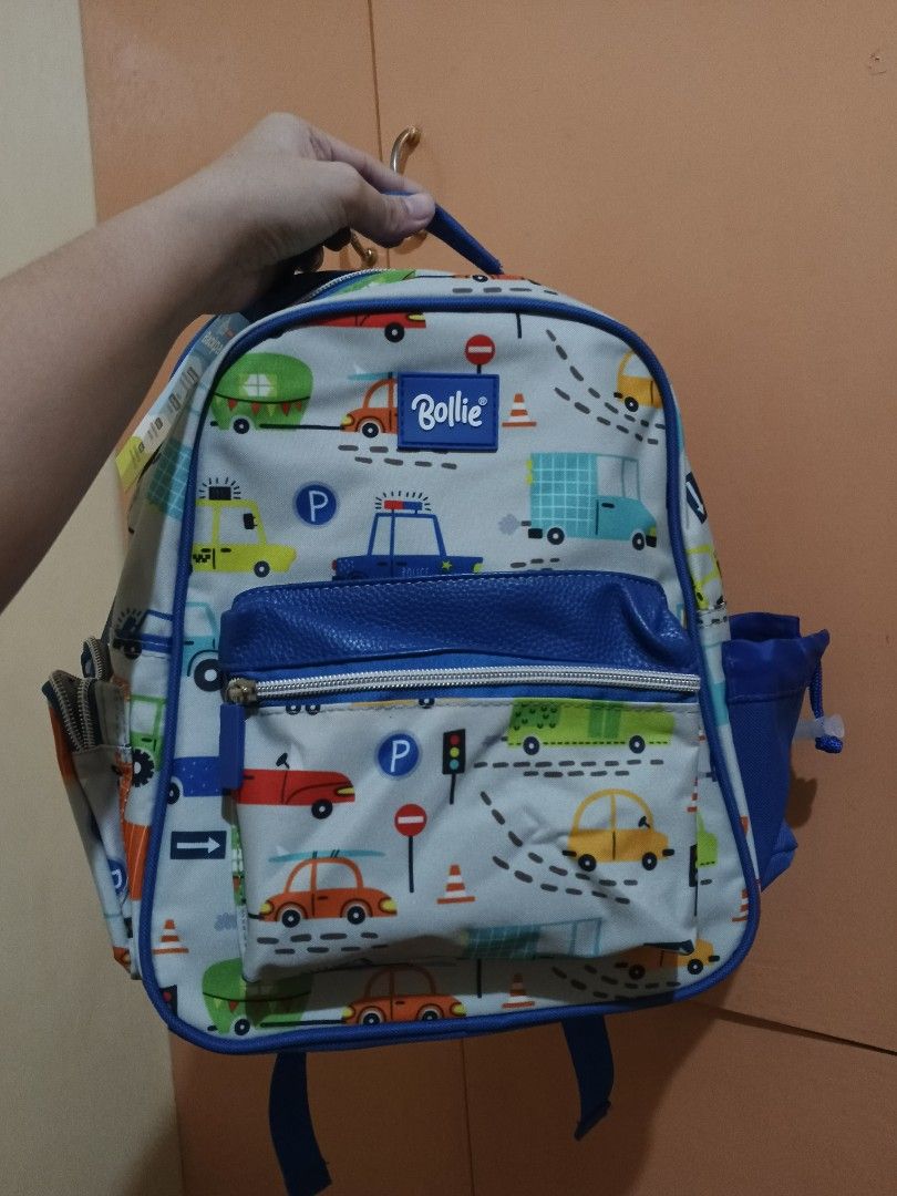Bollie Kiddie Backpack Car Print (Category: Other Babies Going Out Needs) located in Lapu Lapu. Submitted by dawatkrist14304 (Listing ID 1470295804, Image 1). Description: - Brand new with tag attached - Fun, colorful cars, trucks, and road signs design on a light grey base - Vibrant blue trim, straps, and side pockets - Front zippered pocket for extra storage - Mesh padded back panel for breathability and comfort - Adjustable shoulder straps wit
