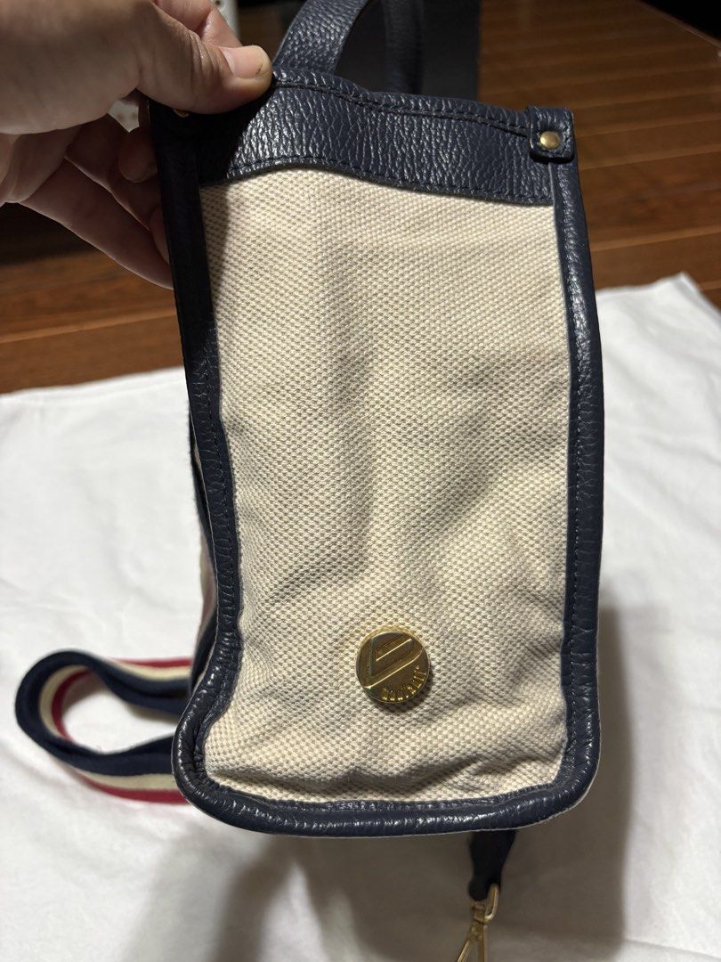 bonfanti made in italy bag (Category: Tote Bags) located in Bulacan. Submitted by love2loved (Listing ID 1470283729, Image 3). Description: - Material: Beige canvas body with dark navy leather trim - Design: Iconic red, cream, and navy striped webbing on front and back - Hardware: Gold-tone hardware with protective metal feet on a structured base - Interior: Clean interior with patterned lining - Versatility: Includes dual top handles and a match
