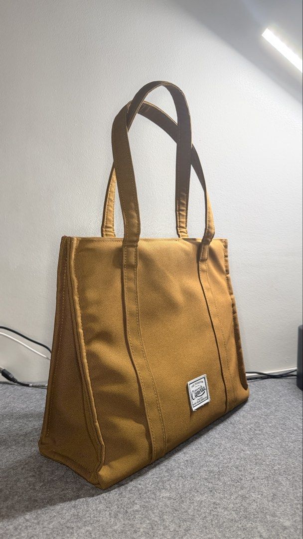 Book Tote Laptop Work Bag (Category: Tote Bags) located in Quezon City. Submitted by mythriftdeals (Listing ID 1470262776, Image 2). Description: Used only twice. RFS: decluttering Dimensions: 30cm x 37cm x 12cm Material: High quality Polyester Canvas fabric Shockproof compartment: Fits 13-14” laptop Small compartments inside 📍Cubao, QC.