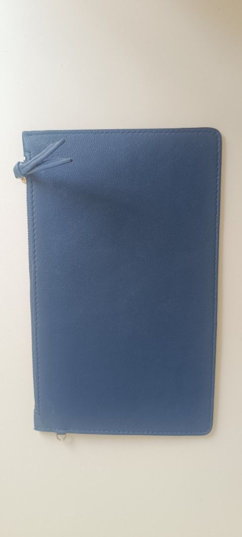 Bottega Veneta Blue Leather Zip Pouch (Category: Luxury Bags & Wallets) located in Subic. Submitted by prelovedwithloveph2019 (Listing ID 1470179629, Image 3). Description: - Brand: Bottega Veneta - Material: Cabat blue leather with brown interior lining - Hardware: Gold-tone front plaque with engraved lettering - Closure: Secure zip closure with a leather pull tab - Design: Clean, simple, and practical for carrying daily essentials - Condition: 