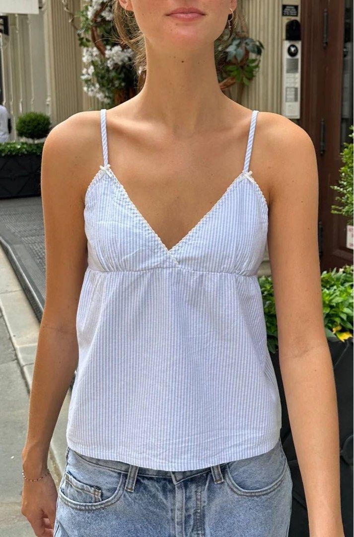 Brandy Blue White Striped Edith Tank Top (Category: Sleeveless) located in Rizal. Submitted by thriiftyy (Listing ID 1470303649, Image 1). Description: used thrice but still good as new, rfs: dont like fit - Color/Pattern: Blue and white stripes - Design: Thin spaghetti straps with delicate white bows - Neckline: V-neck with charming lace trim - Fit: Relaxed and comfortable style - Styling: Perfect to pair with your favorite denim/jeans - Conditi