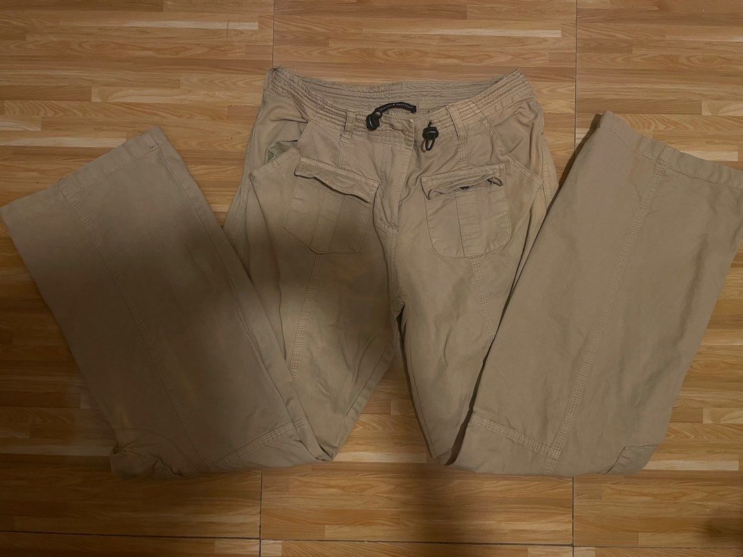 Brandy Melville Beige Cargo Pants (Category: Jeans) located in Cavite. Submitted by mpetalver04 (Listing ID 1470272439, Image 1). Description: - Brand: Brandy Melville - Color: Classic neutral beige (earth tone) - Fit: Relaxed straight leg with visible panel seams - Waist: Adjustable drawstring with secure toggles - Pockets: Multiple functional utility pockets on front and back - Styling: Pairs effortlessly with crop tops and basic tees - Conditi