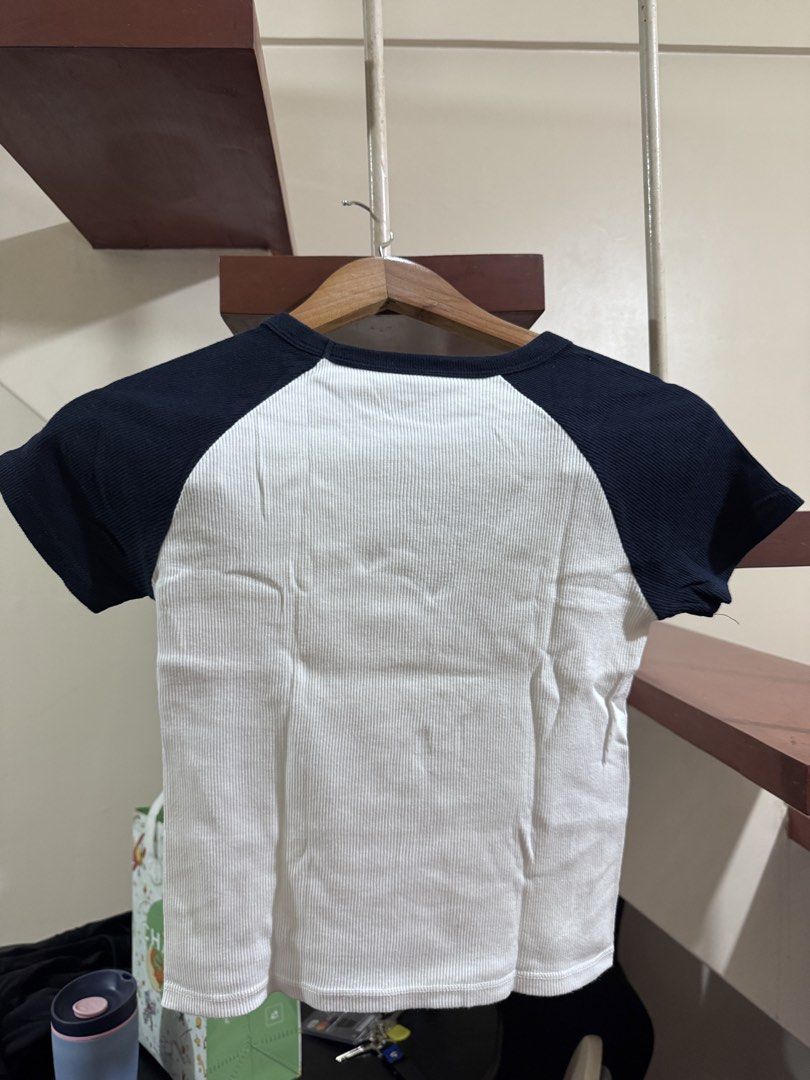 Brandy melville/john galt cropped tee (Category: Shirts) located in Quezon City. Submitted by peanutsquash (Listing ID 1470225698, Image 2). Description: - ribbed knot white with dark navy blue contrast sleeves - bought in the US - selling low, not my style and never reached out for it :"( help me get rid of it hahah.