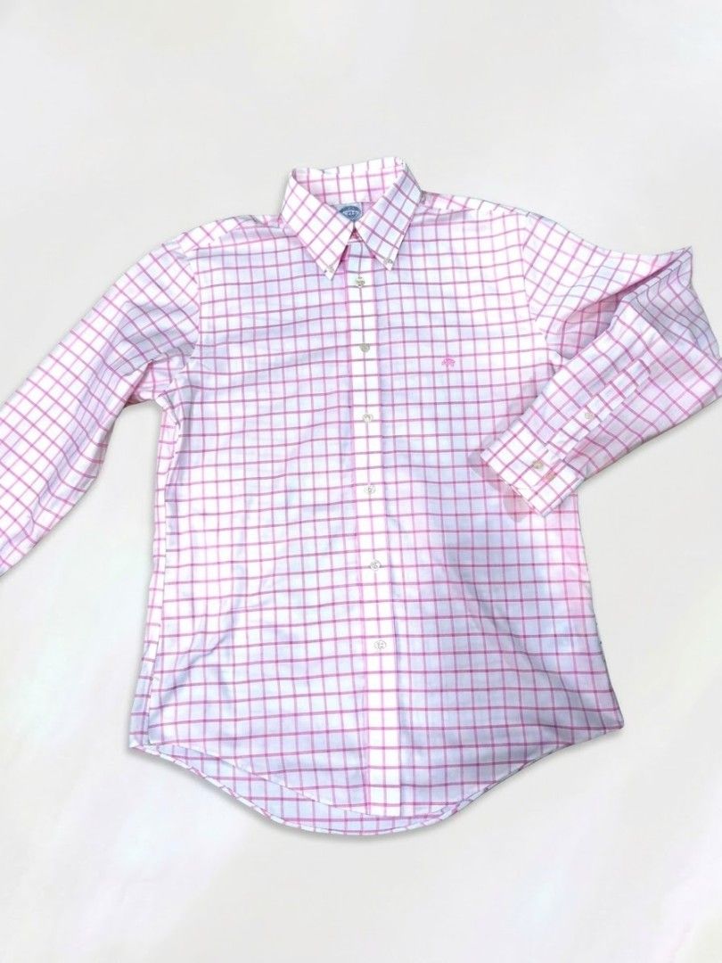 Brooks Brothers Pink White Plaid Button Down Shirt (Category: Tshirts & Polo Shirts ) located in Caloocan City. Submitted by wan_l_as (Listing ID 1470218150, Image 2). Description: - Brand: Brooks Brothers - Pattern: Pink and white windowpane check - Style: Classic button-down collar with front placket and buttoned cuffs - Details: Signature embroidered logo on the chest, long sleeves, and curved hem - Condition: Clean fabric with bright, vibrant