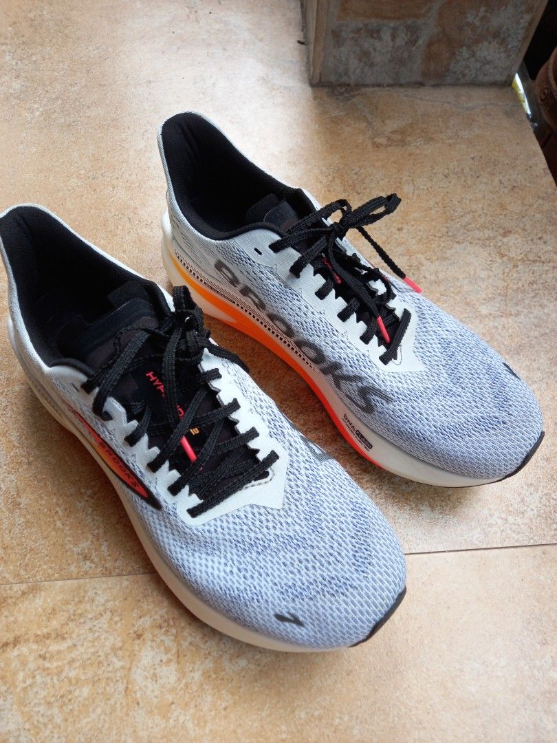 Brooks Hyperion GTS Running Shoes (Category: Sneakers) located in Davao. Submitted by kirk214red-50020 (Listing ID 1470217014, Image 2). Description: - Brand: Brooks Hyperion GTS Performance Running Shoes - Colorway: White with striking orange and red gradient midsoles and black laces - Cushioning: DNA FLASH nitrogen-infused tech for lightweight responsiveness - Upper: Breathable engineered mesh with supportive Go To Support side stripes - Condit