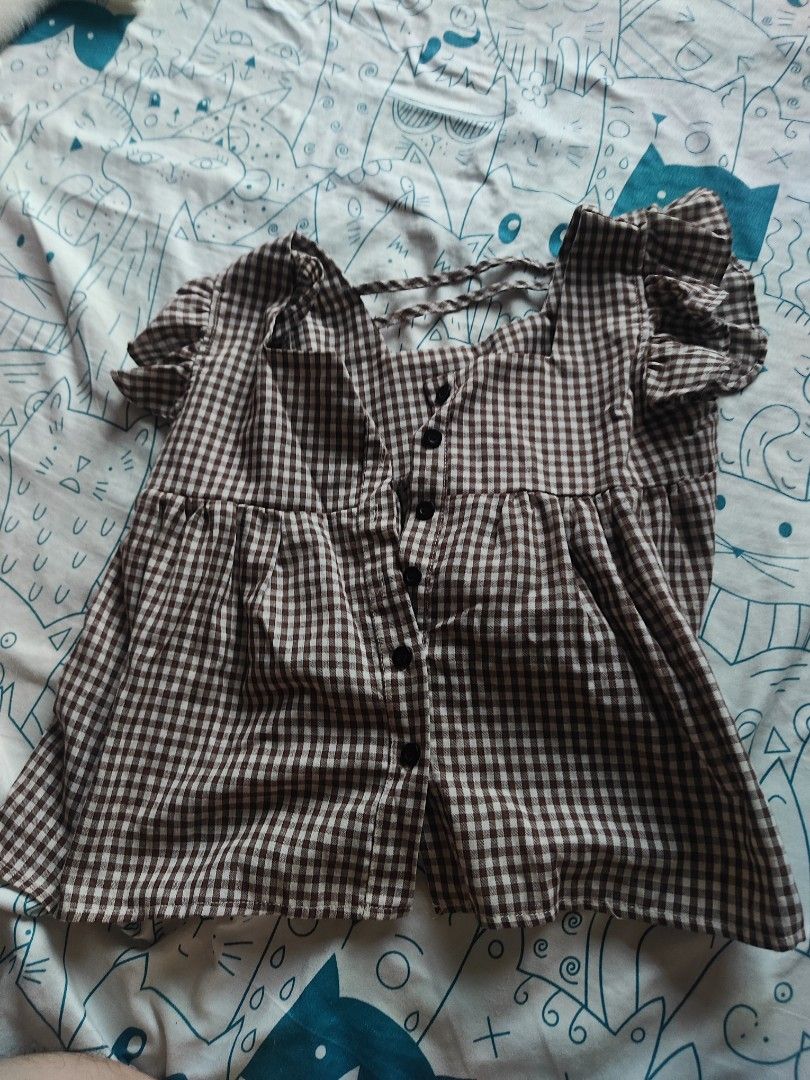 Brown Gingham Ruffle Sleeve Blouse Size S (Category: Blouses) located in Caloocan City. Submitted by MovesLikeJeager (Listing ID 1470188483, Image 1). Description: - Size: S - Pattern: Brown and white gingham - Material: 100% polyester (lightweight and comfortable) - Design: Ruffled flutter sleeves, button-down front closure, square neckline - Back Details: Strap detail at the back - Perfect for: Casual days out and everyday styling.