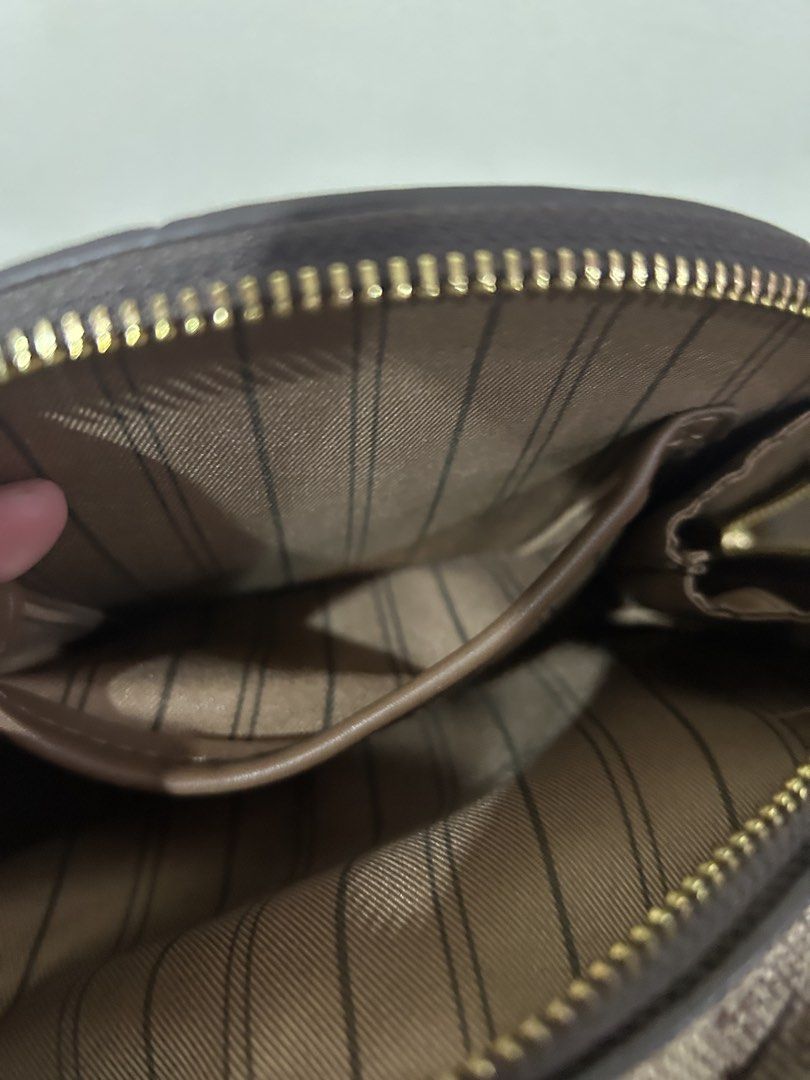 Brown Monogram Circle Crossbody Bag with Top Handle (Category: Cross-body Bags) located in Marilao. Submitted by bamito (Listing ID 1470166883, Image 2). Description: - Style: Round crossbody bag with checkered monogram print - Color: Brown with dark brown leather trim - Hardware: Gold-tone accents including top zipper closure - Straps: Includes a matching top handle and an adjustable shoulder strap .