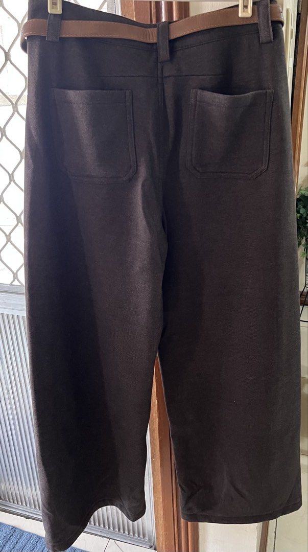 Brown pants (Category: Jeans) located in Bacoor. Submitted by ayit. (Listing ID 1470171048, Image 2). Description: Bnew orig japan Sf inc - Color: Dark brown - Fit: High waist with a long, straight wide-leg cut - Details: Front center button closure, front pockets, and back patch pockets - Bonus: Includes a matching tan leather belt with a silver-tone buckle - Styling: Easy to mix and match for casual or smart casual outfits.