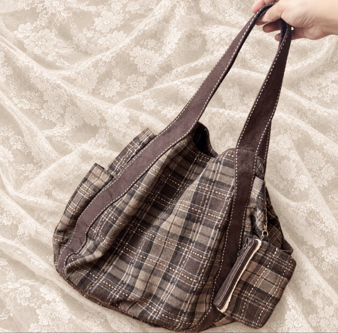 Brown plaid canvas shoulder bag with matching pouch (Category: Shoulder Bags) located in Manila. Submitted by calliope777 (Listing ID 1470214537, Image 2). Description: - Stylish brown plaid canvas shoulder bag - Spacious main compartment with secure magnetic button closure - Convenient inner zipper pocket and side pockets for organization - Durable, thick fabric straps featuring contrast stitching - Includes a cute matching zippered pouch attach