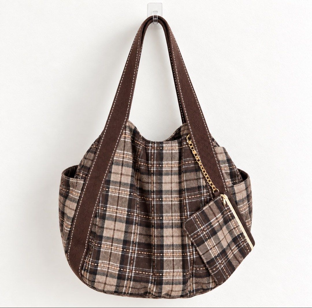 Brown plaid canvas shoulder bag with matching pouch (Category: Shoulder Bags) located in Manila. Submitted by calliope777 (Listing ID 1470214537, Image 1). Description: - Stylish brown plaid canvas shoulder bag - Spacious main compartment with secure magnetic button closure - Convenient inner zipper pocket and side pockets for organization - Durable, thick fabric straps featuring contrast stitching - Includes a cute matching zippered pouch attach