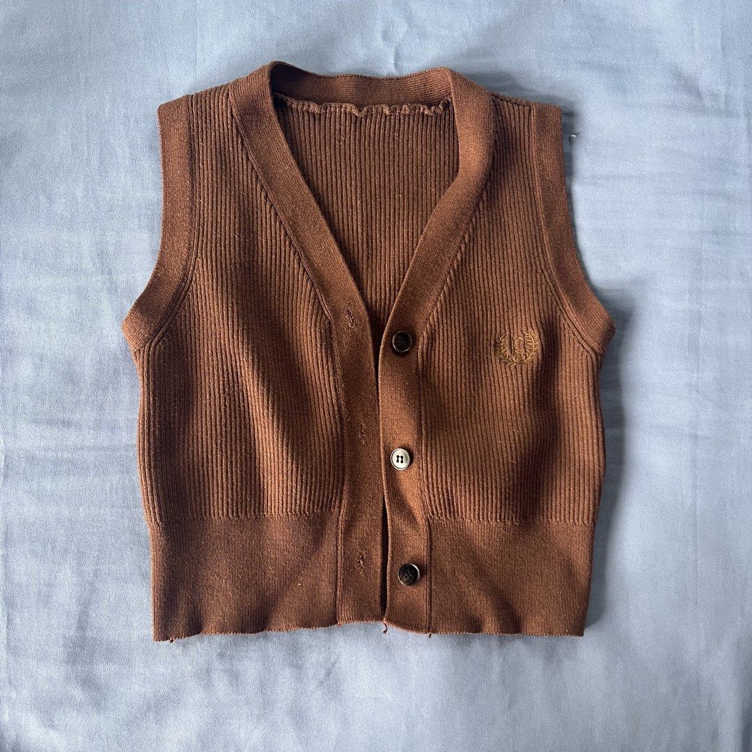 Brown Ribbed Knit Button-Up Vest (Category: Sleeveless) located in Bocaue. Submitted by frankie_1818 (Listing ID 1470191409, Image 2). Description: - Color: Brown - Fit: Cropped length, can fit small to medium, soft and comfortable material - Styling: Perfect for layering over shirts or wearing solo Loc: UST Manila.