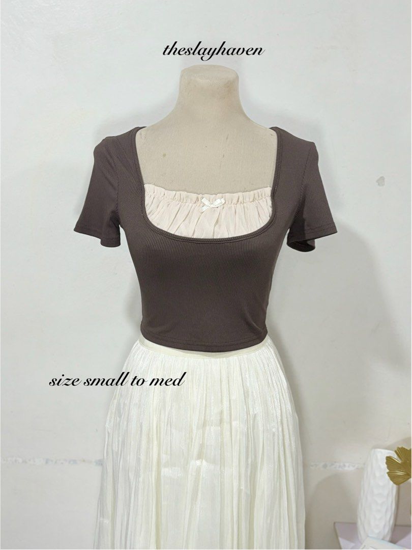 Brown Square Neck Layered Crop Top with Bow (Category: Sleeveless) located in Manila. Submitted by biacakes (Listing ID 1470261908, Image 1). Description: - Color: Brown with cream layered neckline and white center bow - Fit: Stretchy fabric, fits small to medium frames comfortably - Style: Short sleeve crop top, perfect with high-waisted skirts or pants - Condition: Brand new / Excellent (ready to wear).