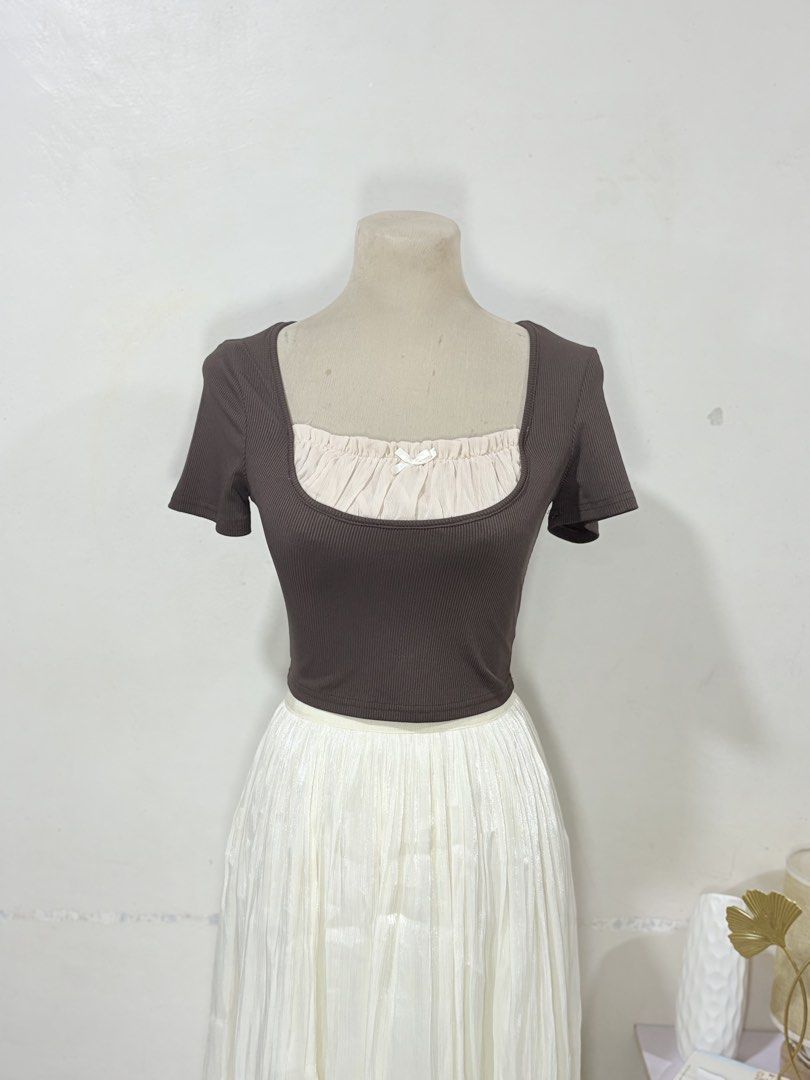 Brown Square Neck Layered Crop Top with Bow (Category: Sleeveless) located in Manila. Submitted by biacakes (Listing ID 1470261908, Image 2). Description: - Color: Brown with cream layered neckline and white center bow - Fit: Stretchy fabric, fits small to medium frames comfortably - Style: Short sleeve crop top, perfect with high-waisted skirts or pants - Condition: Brand new / Excellent (ready to wear).