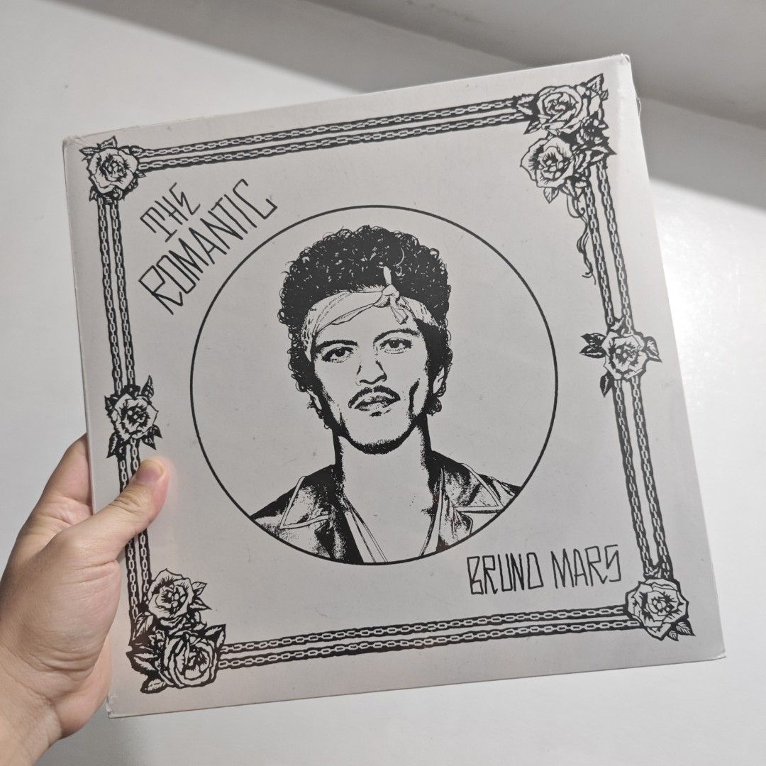 Bruno Mars The Romantic Vinyl Record (Numbered/Limited Edition) (Category: Vinyls) located in Makati City. Submitted by prinsguessallgone (Listing ID 1470293693, Image 1). Description: - Artist & Album: Bruno Mars - The Romantic - Format: Vinyl LP (Made in Poland, Atlantic Records) - Rarity: Hand-numbered limited edition, #11442 out of 25,000 - Cover Art: Black and white illustrated portrait framed by roses and chains - Tracklist: Risk It All, Ch