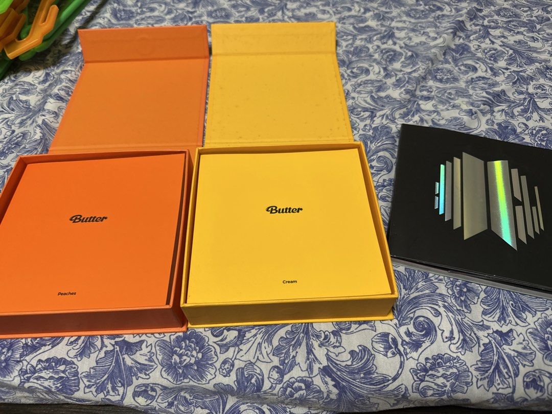 BTS Butter and Proof Albums (Category: K-Wave Merchandise) located in Bacoor. Submitted by yoonkibox (Listing ID 1470250375, Image 2). Description: NO PHOTOCARDS - Official BTS merchandise featuring Butter (Cream & Peaches versions) and Proof albums - Includes vibrant yellow and orange Butter boxes and the sleek black Proof album - Great addition to any ARMY's collection or display.
