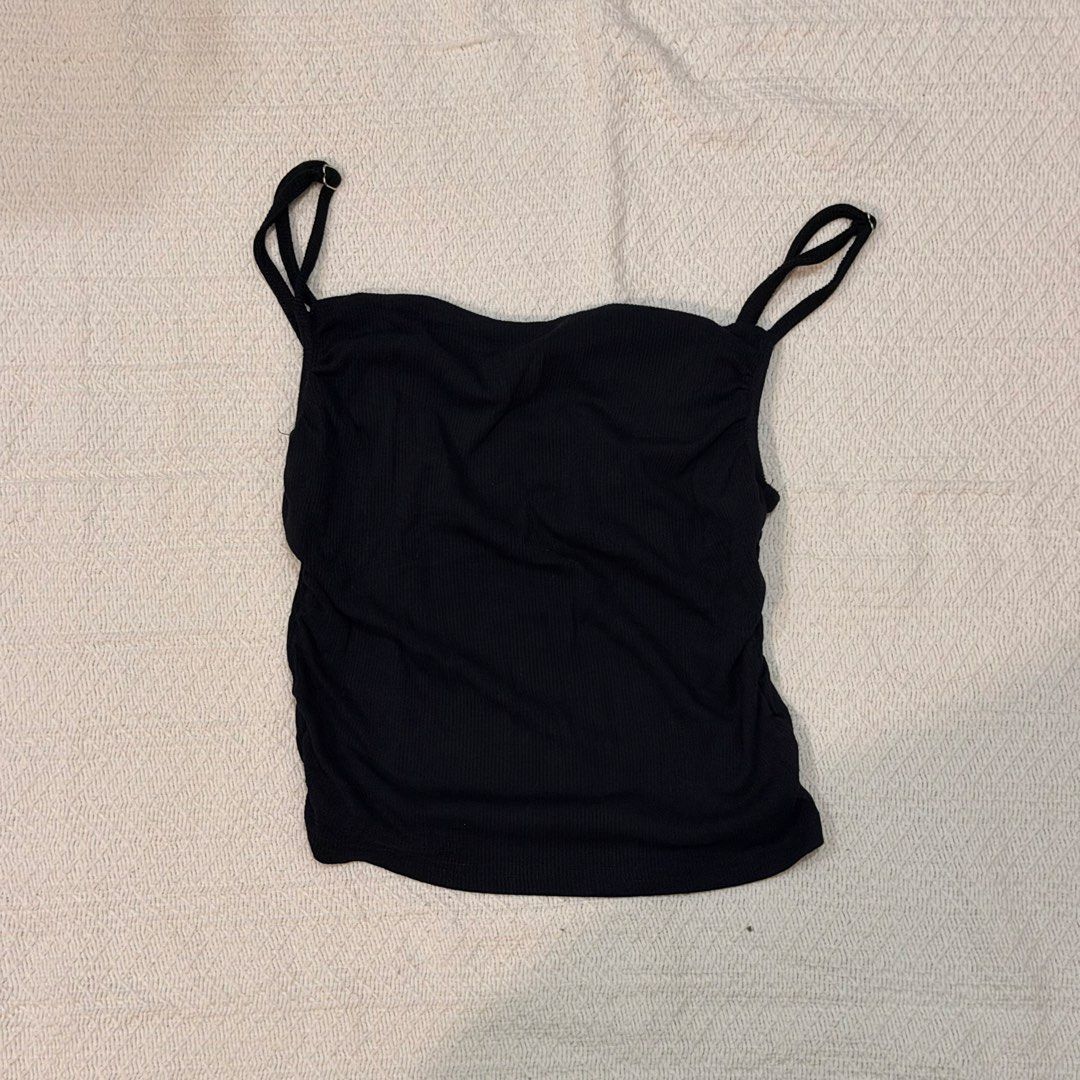 Bundle of 4 black tops and tanks (Category: Sleeveless) located in Makati City. Submitted by banshee1411 (Listing ID 1470253452, Image 2). Description: Bundle of 4 essential black tops - ribbed mock neck sleeveless top - racerback crop top - camisole with criss-cross back straps - ruched spaghetti strap top .