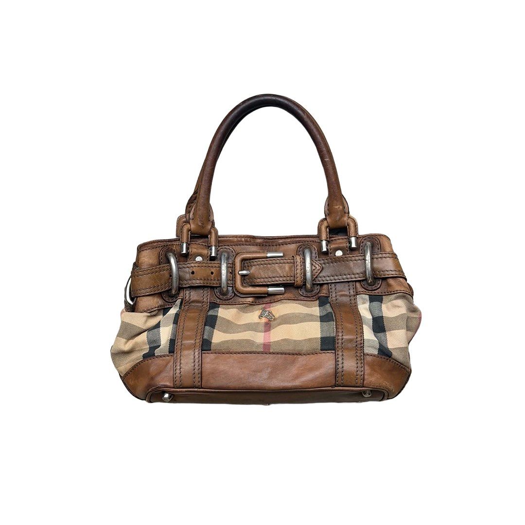 Burberry Beaton (Category: Luxury Bags & Wallets) located in Manila. Submitted by angelconscious (Listing ID 1470283914, Image 1). Description: Very rare burberry beaton, however shes been well used by the previous owner 💔 still presentable in a way. She can fit a 11 inch ipad perfectly, and she can suprisingly fit a lot of item for a medium size bag Major issues consists of: Exposed piping Small tear in fabric in the back Rust stain on canvas d