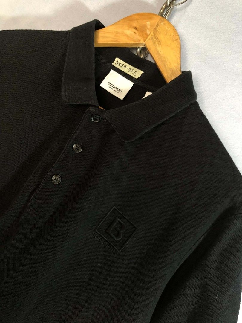 Burberry Black Polo Shirt (Category: Tshirts & Polo Shirts ) located in Caloocan City. Submitted by oldmoneyoutfit24 (Listing ID 1470234085, Image 3). Description: - Authentic Burberry black polo shirt - Classic pique cotton material for all-day comfort - Subtle tonal black 'B' monogram embroidered patch on chest - Standard collar with a 3-button branded placket - Versatile and easy to style for smart-casual looks - Size and measurements found on