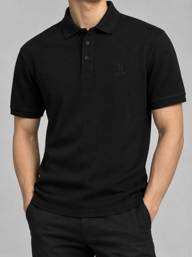 Burberry Black Polo Shirt (Category: Tshirts & Polo Shirts ) located in Caloocan City. Submitted by oldmoneyoutfit24 (Listing ID 1470234085, Image 1). Description: - Authentic Burberry black polo shirt - Classic pique cotton material for all-day comfort - Subtle tonal black 'B' monogram embroidered patch on chest - Standard collar with a 3-button branded placket - Versatile and easy to style for smart-casual looks - Size and measurements found on