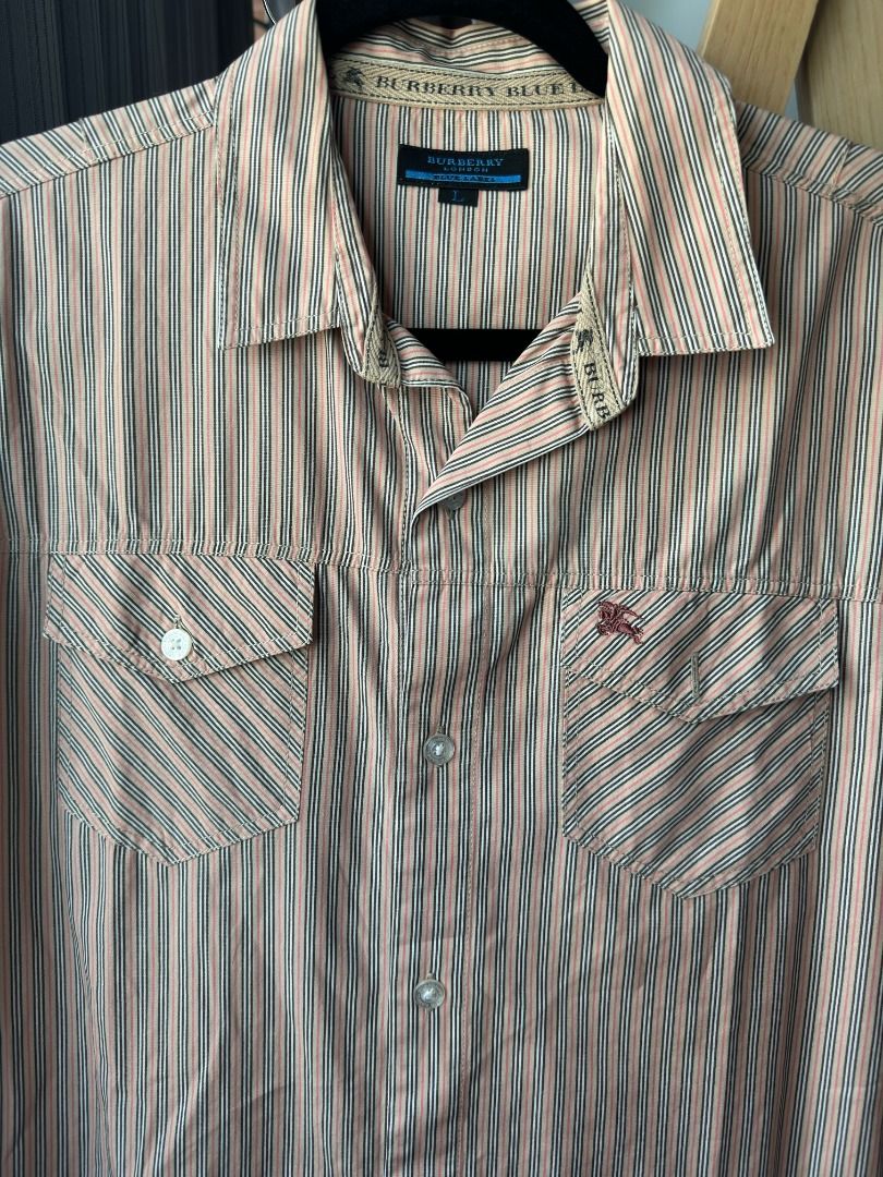 Burberry Blue Label Long Sleeve Striped Button Down Shirt Large (Category: Formal Shirts) located in Cebu City. Submitted by _t.rix (Listing ID 1470199033, Image 3). Description: - Brand: Burberry Blue Label - Size: L (based on interior tag) - Design: Multicolor striped pattern (peach, black, and white tones) - Details: Classic collar, front button closure, two button-flap chest pockets - Branding: Small embroidered equestrian knight logo on left