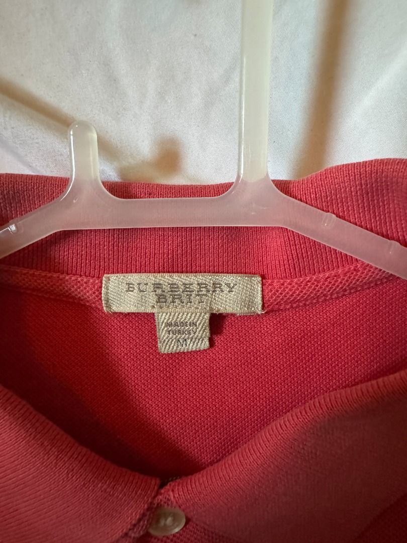 Burberry Brit Red Polo Shirt Size M (Category: Tshirts & Polo Shirts ) located in Cebu City. Submitted by _t.rix (Listing ID 1470175391, Image 2). Description: - Brand: Burberry Brit - Color: Red - Size: Medium (true to size) - Material: 100% cotton (super soft and breathable) - Details: Classic collar, two-button placket, subtle embroidered knight logo on chest - Origin: Made in Turkey - Condition: Clean inside and out, labels fully intact.