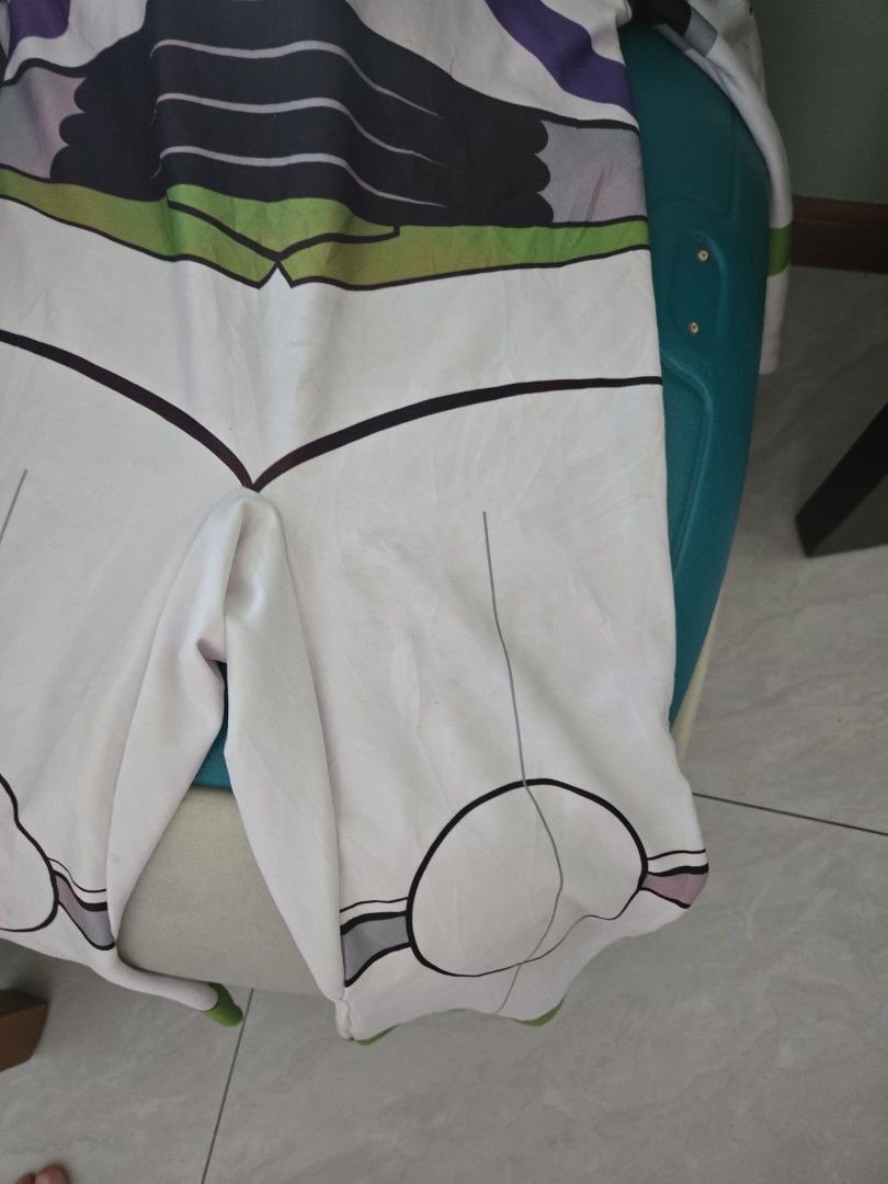 Buzz Lightyear Costume Toy Story (Category: Babies & Kids Fashion) located in Pasig City. Submitted by izzy0202 (Listing ID 1470144740, Image 2). Description: -6 to 8 ay see faded hood and needs cleaning Iconic Buzz Lightyear full body costume (green, white, and purple) - Features printed control panel graphics and attached hood - Stretchy fabric for a comfortable fit - Easy to slip on and off - Ideal for parties, dress-up, and Halloween events.