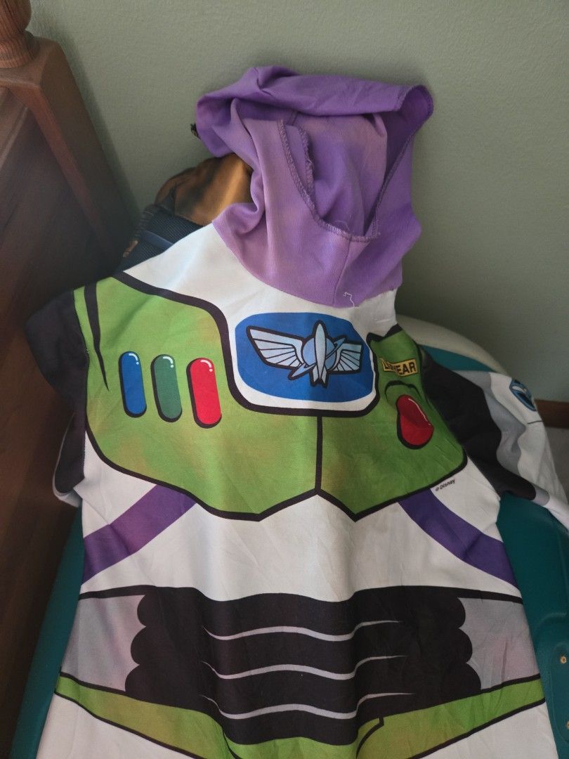 Buzz Lightyear Costume Toy Story (Category: Babies & Kids Fashion) located in Pasig City. Submitted by izzy0202 (Listing ID 1470144740, Image 3). Description: -6 to 8 ay see faded hood and needs cleaning Iconic Buzz Lightyear full body costume (green, white, and purple) - Features printed control panel graphics and attached hood - Stretchy fabric for a comfortable fit - Easy to slip on and off - Ideal for parties, dress-up, and Halloween events.