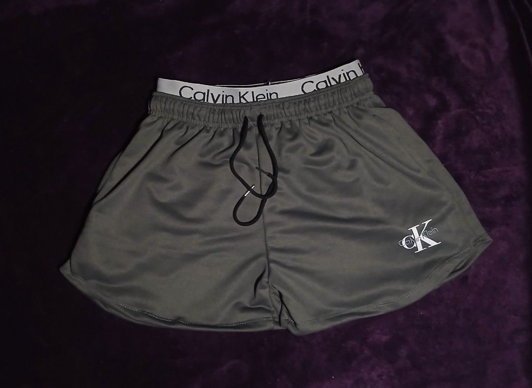 ‼️Calvin Klein Athletic Shorts with Drawstring (Category: Shorts) located in Caloocan City. Submitted by yat0zu (Listing ID 1470276639, Image 1). Description: - Brand: Calvin Klein - Color: ARMY GREEN - Style: Athletic shorts / Lounge wear - Waistband: Elastic with bold Calvin Klein branding and adjustable black drawstrings - Branding: Small white Calvin Klein logo on the lower left leg - Design: Curved hem for enhanced mobility and comfort - Mat