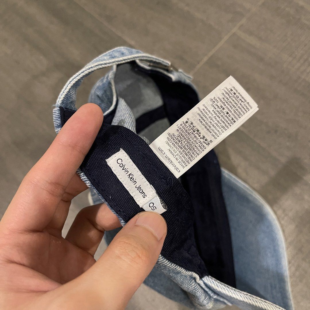 Calvin Klein Denim Baseball Cap (Category: Caps & Hats) located in Manila. Submitted by ig_i.00 (Listing ID 1470237335, Image 3). Description: - Calvin Klein - No issues - Light washed denim baseball cap with navy blue interior lining .
