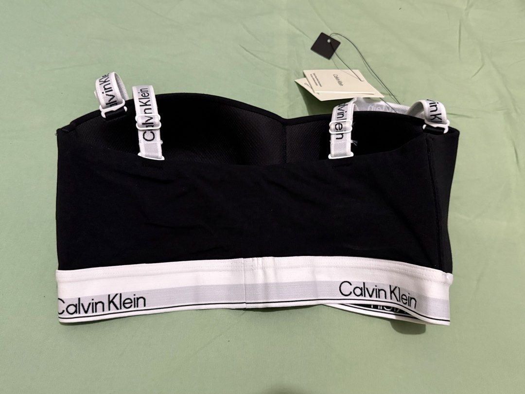 Calvin Klein Lightly Lined Bandeau Bra Black Size M (Category: Undergarments & Loungewear) located in Binan City. Submitted by just4stuffs (Listing ID 1470204126, Image 3). Description: - Brand: Calvin Klein - Style: Lightly lined bandeau bra - Color: Black with white elastic underband - Size: Medium (M) - Condition: Brand new with original tags attached, never worn - Features: detachable straps.