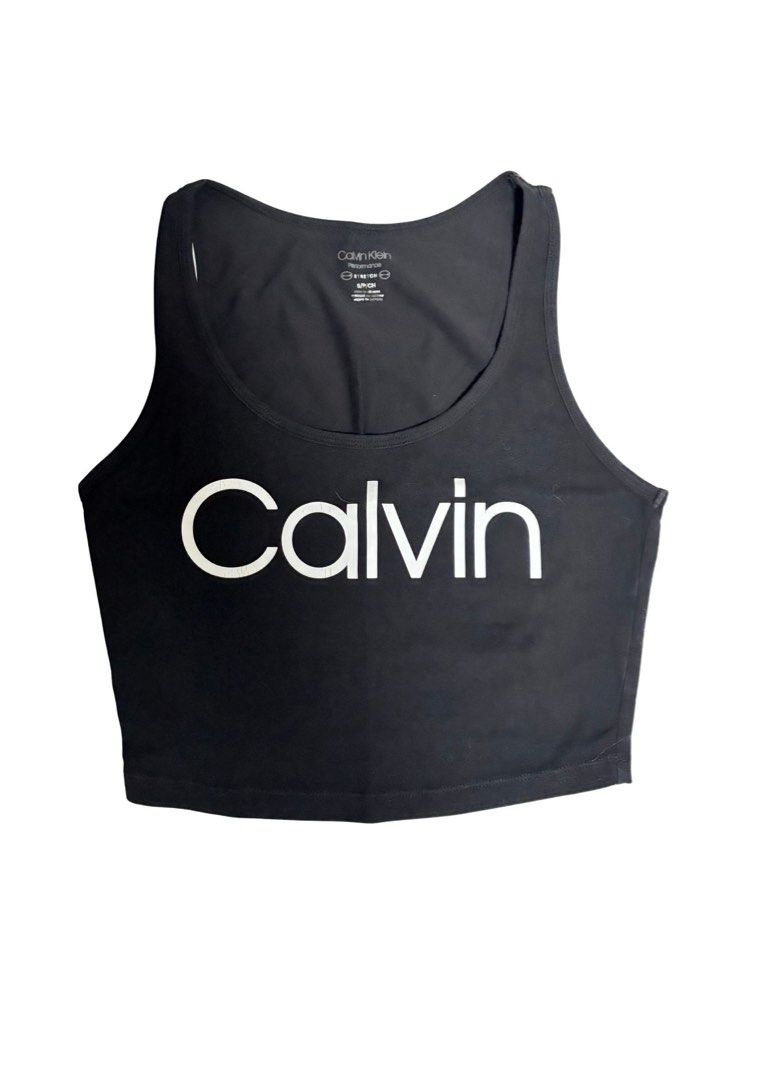 Calvin Klein Performance Black Crop Tank Top (Category: Sleeveless) located in Caloocan City. Submitted by shibowhii (Listing ID 1470222564, Image 1). Description: - Brand: Calvin Klein Performance - Size: S (inner label) - Color: Black with white block lettering - Design: Scoop neckline, thick shoulder straps, crop top fit - Material: Comfortable stretch fabric blend - Best for: Workouts, gym sessions, or casual everyday wear - Care: Machine was