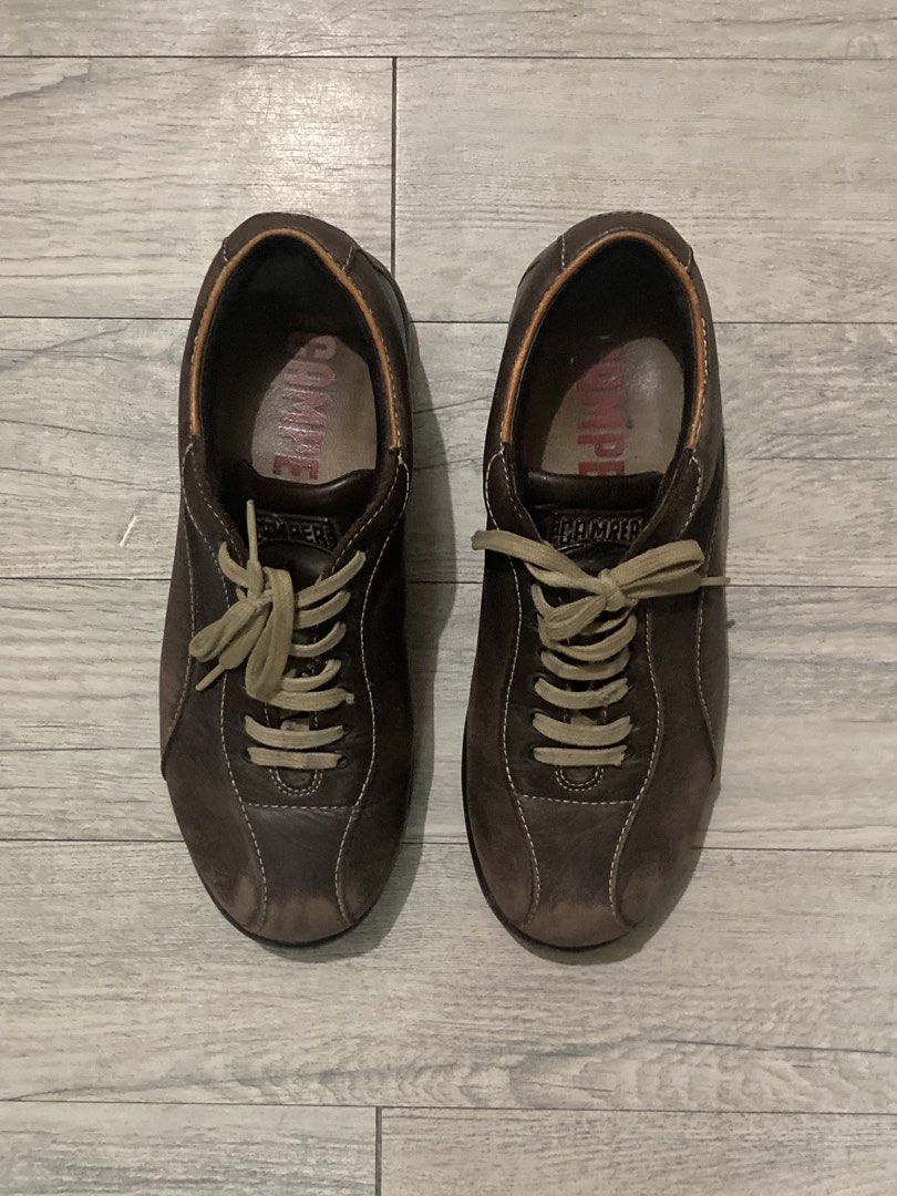 Camper Brown Leather Casual Sneakers (Category: Sneakers) located in Manila. Submitted by rndmthrift (Listing ID 1470258071, Image 1). Description: - Brand: Camper - Color: Brown leather with contrast beige laces - Details: Visible front panel stitching, branded insoles with red Camper text - Soles: Durable rubber soles for all-day comfort - Condition: Light scuffing on the toe caps from regular wear - Style: Versatile and comfortable everyday sn